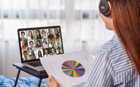 Rear view of Asian woman working and online meeting via video co